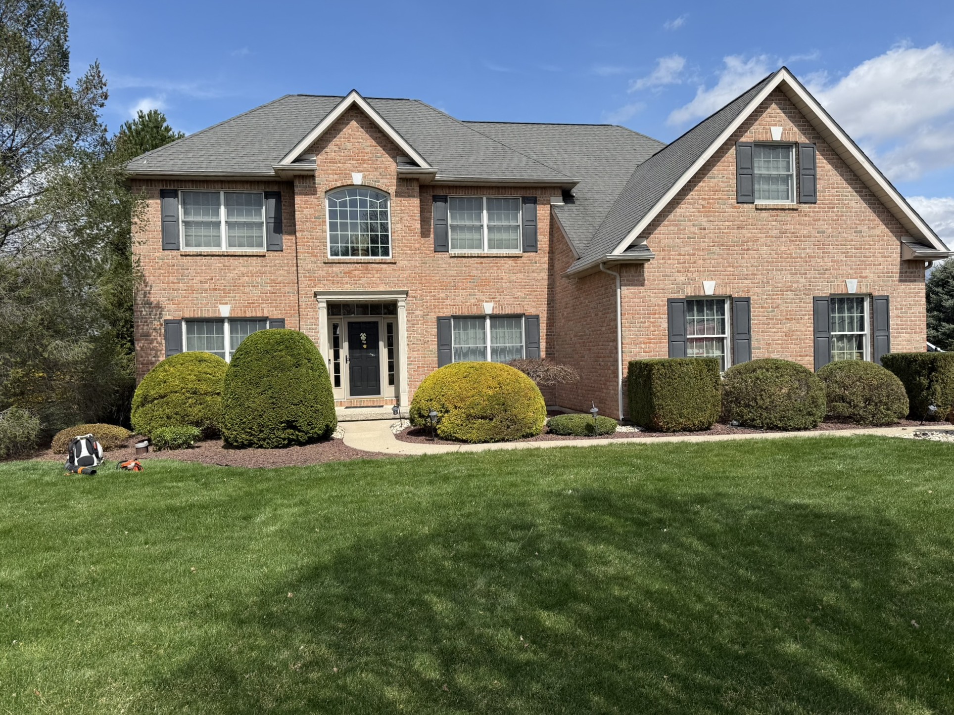 Clean front yard landscaping with trimmed shrubs, fresh mulch beds, and maintained lawn in Lehighton, PA