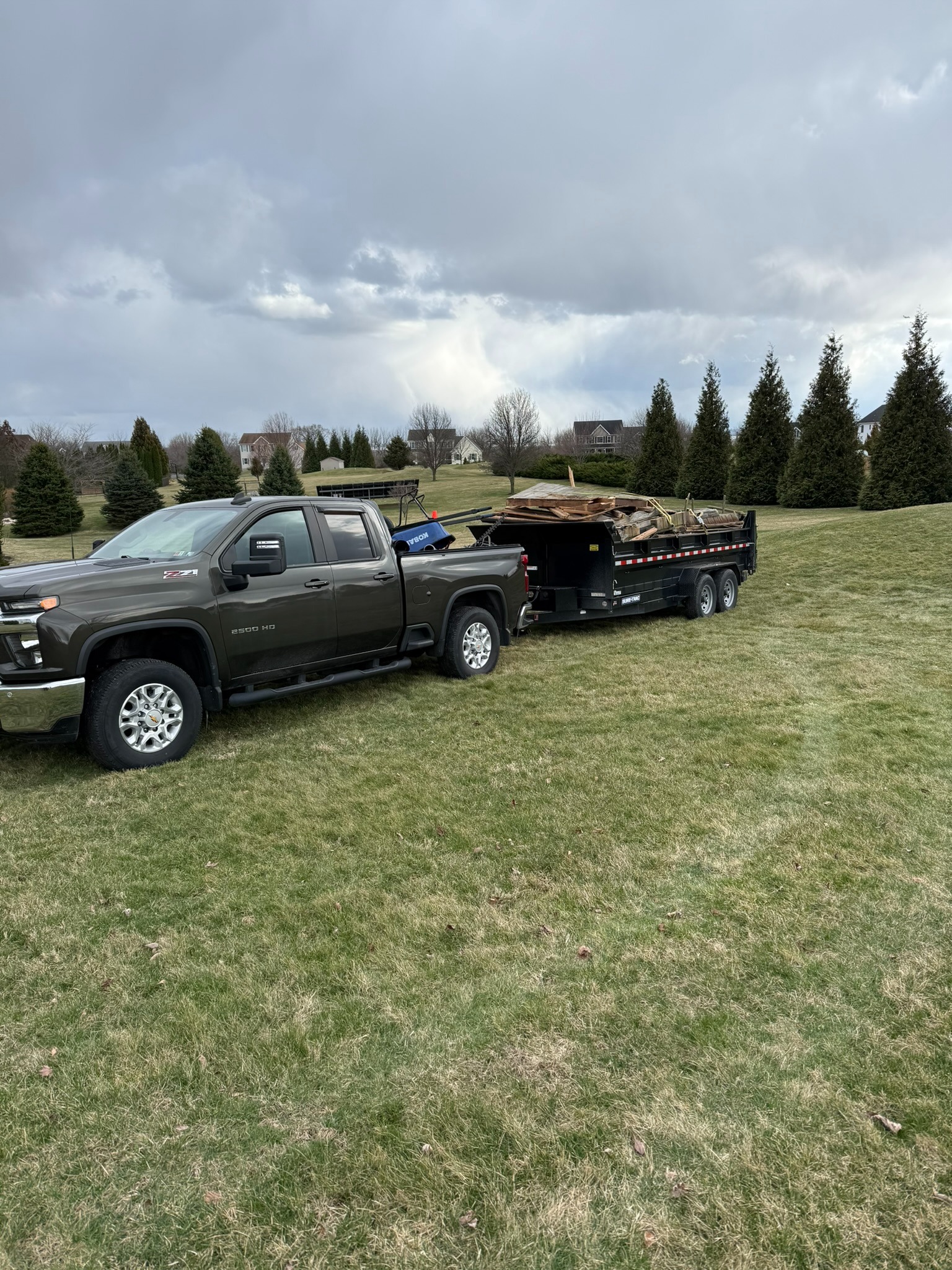 Dump trailer loaded with yard debris for hauling service