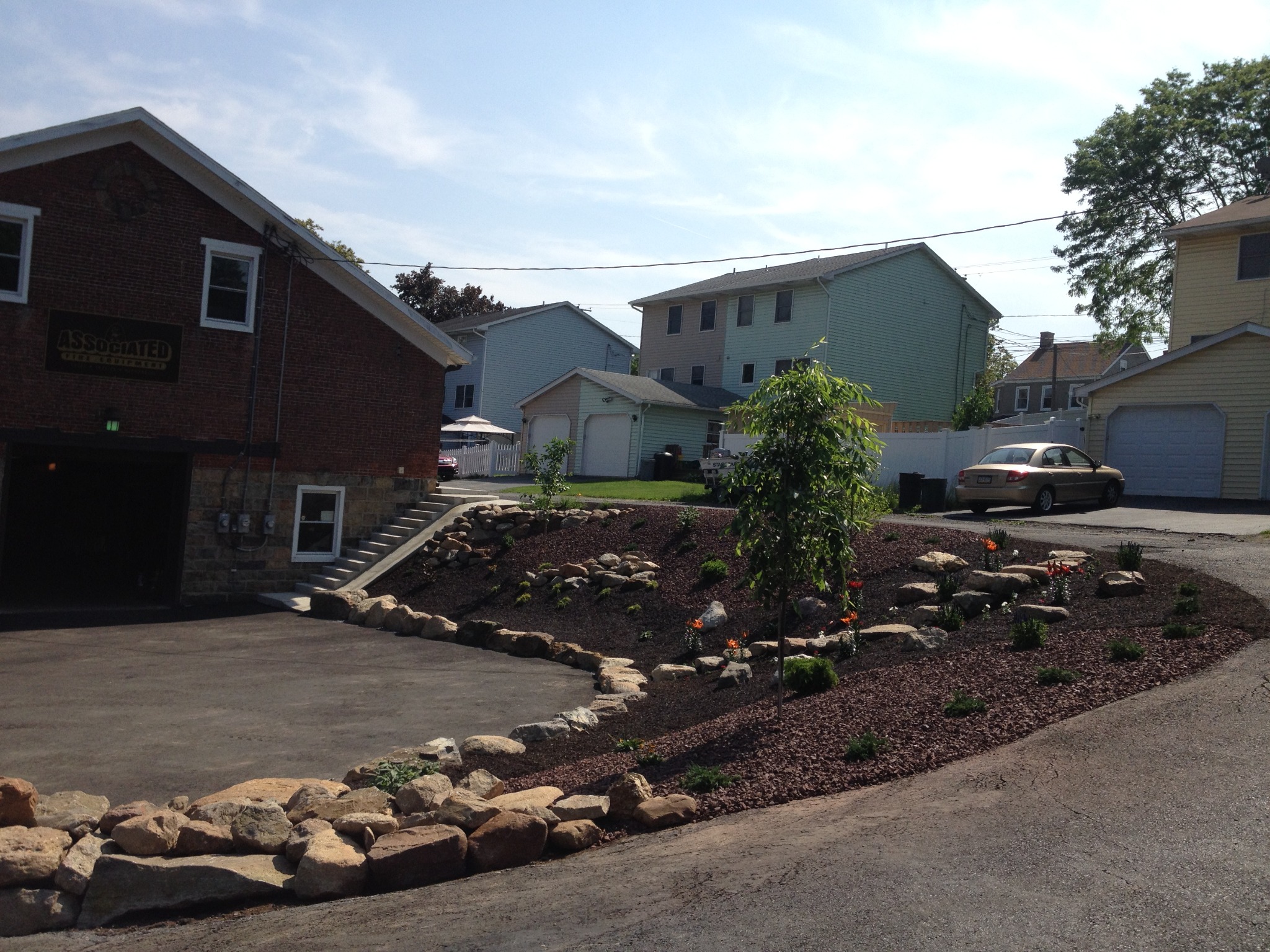 Natural stone edging and mulch detail on commercial landscape island