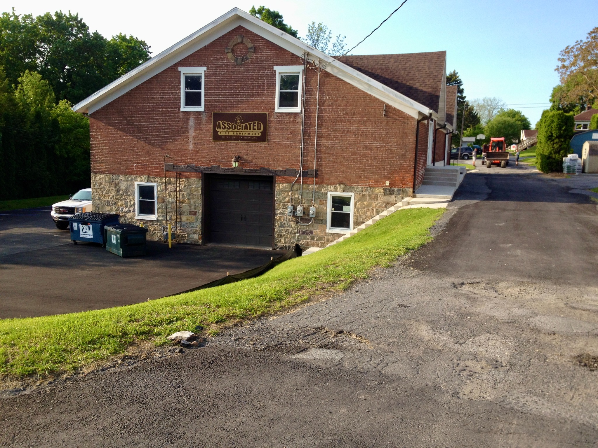 Wide view of completed new home landscape installation and lawn