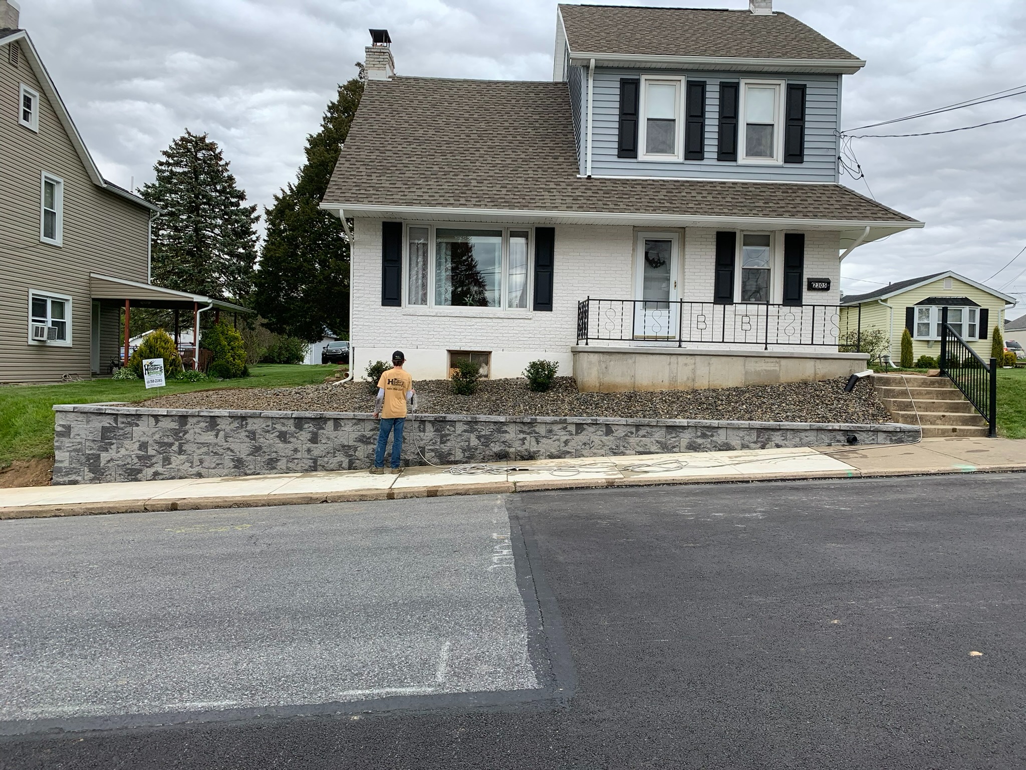 Front yard after cleanup with newly installed stone landscape bed